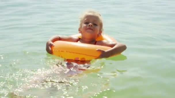 Child swims sea inflatable ring. danger of drowning Safety equipment, Child Life buoy — Stock Video