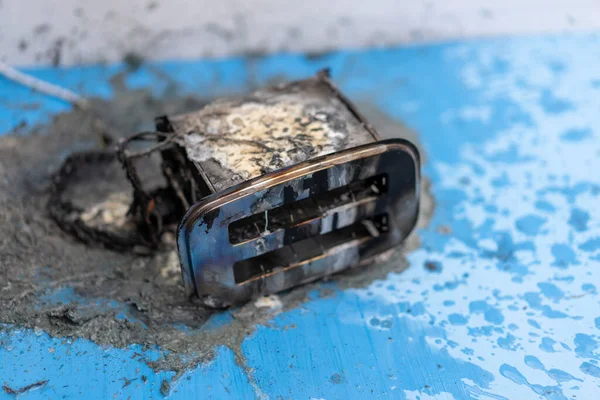 Toaster after fire. Household electrical appliance fire hazard. Overload. Short circuit. Carelessness. Safety in home. Danger home inflammation Insurance concept