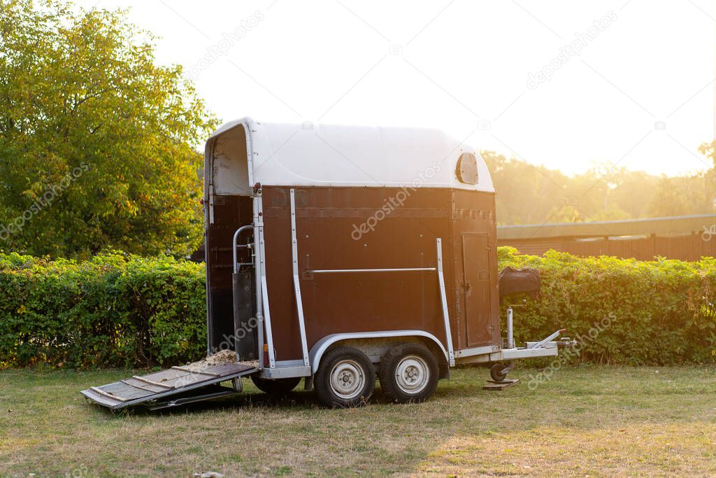 Horse trailer standing outdoor with open door. vehicle for horse transportation Travel with animals 