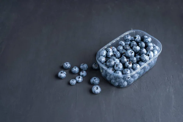 Tasty Juicy Raw Blueberries Plastic Container Black Dark Background Packaging — Stock Photo, Image