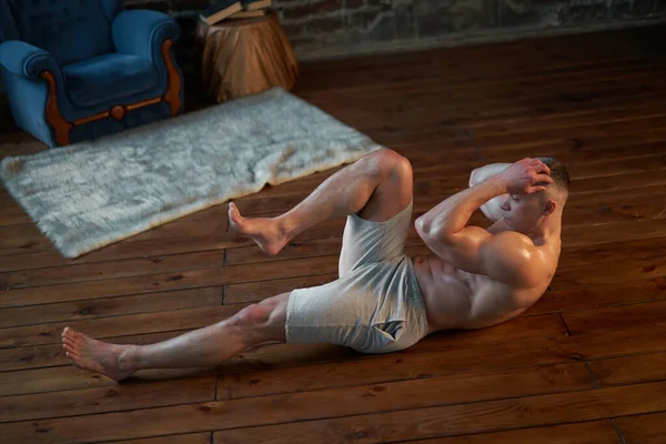Trening Wytrzymałościowy Silny Muskularny Mężczyzna Pompy Mięśnie Brzucha Domu Wnętrze — Zdjęcie stockowe