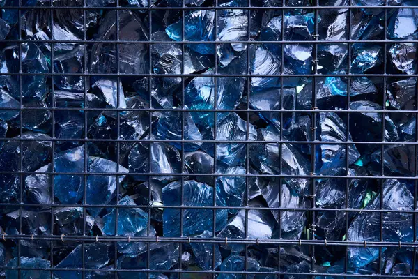 Blue Crystal Mineral Stone. Gems. Artificial crystals in stone cage modern construction wall background Texture of precious and semiprecious stones. colored shiny surface of precious stone