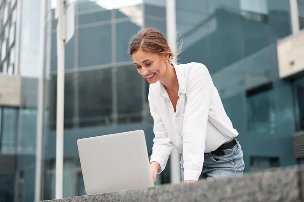 Businesswoman successful woman business person outdoor corporate building exterior with laptop Pensive elegance cute caucasian professional business woman middle age ecommerce deal Online banking