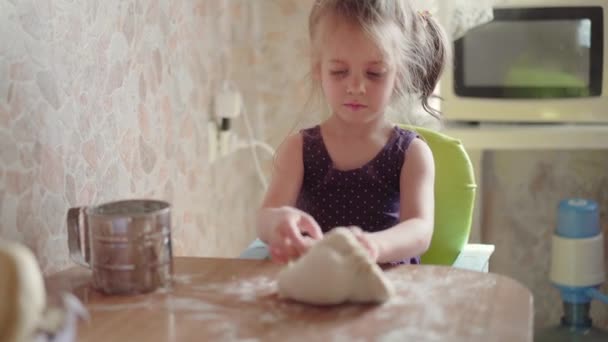 Little Girl With Dough On Kitchen. Child Learns Cook — Stock Video