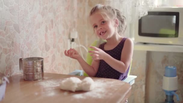 Little Girl With Dough On Kitchen. Child Learns Cook — Stock Video