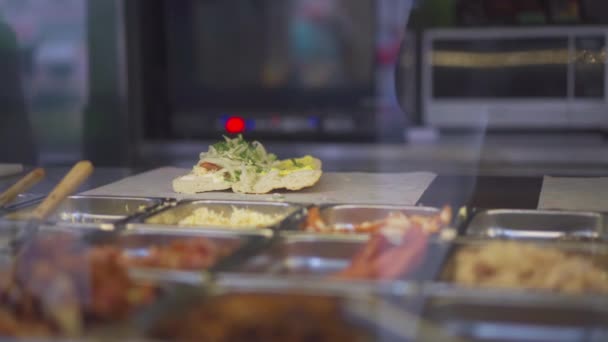 Female street vendor hands making sandwich outdoors. cuisine snacks, cooking fast food for commercial kitchen. — Stock Video