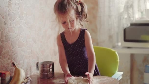 Little Girl With Dough On Kitchen. Child Learns Cook — Stock Video