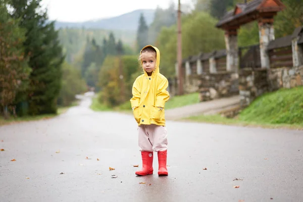 Speels Meisje Dragen Gele Regenjas Terwijl Springen Plas Tijdens Regenval — Stockfoto