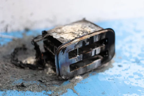 Toaster after fire. Household electrical appliance fire hazard. Overload. Short circuit. Carelessness. Safety in home. Danger home inflammation Insurance concept