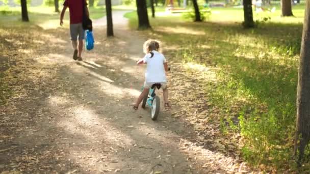 Детская езда Баланс Велосипед Страна Road Park задний вид Солнечный летний день — стоковое видео