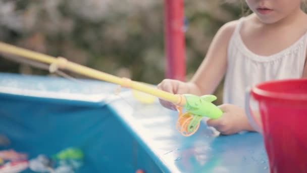 Child Fisher Catching Plastic Toy Fish On Pool Amusement Park Summer Day — Stok Video