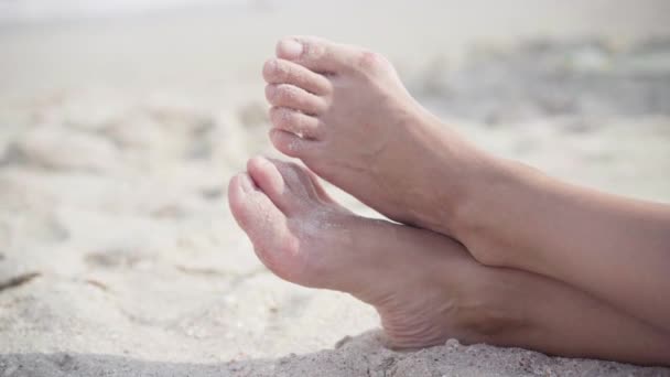 Hallux valgus on female legs close up on beach sand. Foot joint deformity. Health care and medicine problem with human body — Stock Video