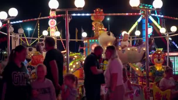 Kirilovka, Ucrania, agosto 2021 Gente caminando Parque de atracciones por la noche — Vídeo de stock