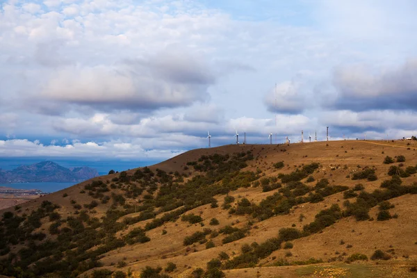 Windmills on the mountain near the sea harbor — Stock Photo, Image