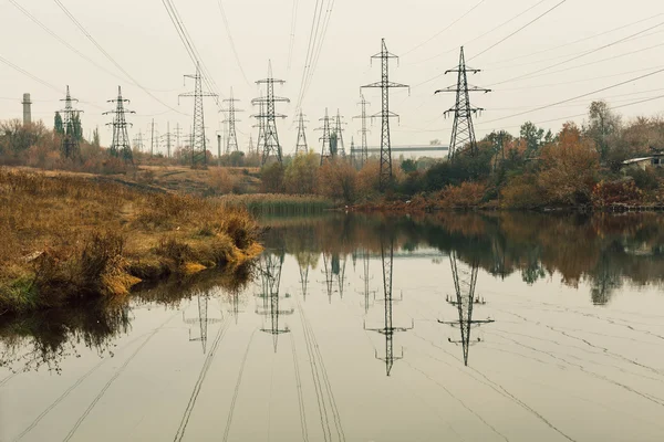 Coal power station in beautiful area full of trees and lake, mirror reflection of energetic pole and power station with chimneys, synergy of industry and nature — Stock Photo, Image