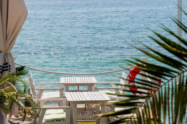 Table in a restaurant on tropical resort with a view of the sea — Stock Photo, Image