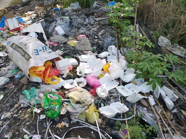 stock image Perak,Malaysia. February 6,2021: Environmental pollution where irresponsible people throw assortment of garbage dumps in the isolated field along the roadside at the Kg Koh Plantation.