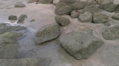 scenery of rocky boulders by the beach