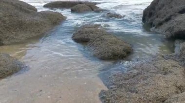 scenery of rocky boulders by the beach