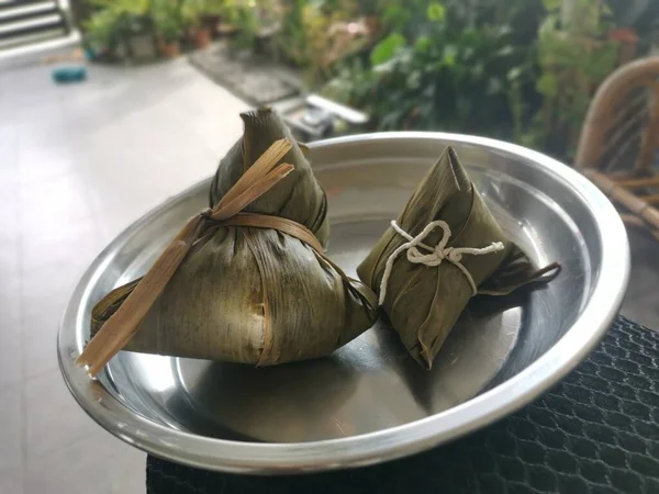 cooked ready and wrapped with bamboo leaves chinese dumpling