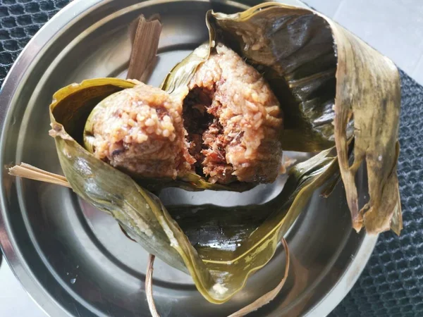 cooked ready and wrapped with bamboo leaves chinese dumpling