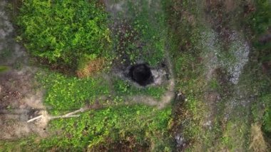 footage of the ascending flight as looking below the agriculture ground and a man walking below.