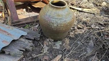 abandoned or thrown away old vintage clay big and small size clay jars at the isolated farm.