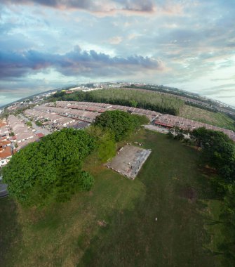 aerial scene of the distance horizon houses at the outskirt of the palm oil plantation.