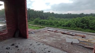 either looking out the window or door frame the outdoor construction site at early dusk or dawn time 