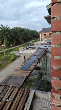 Yarışın etrafındaki olay yeri, balkondan bakan iki katlı bir ev..