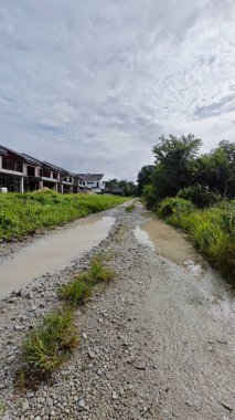 Kırsal kesimdeki kırsal kesime doğru olan perspektif boyunca durgun yağmur suyu havuzu 