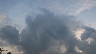 Looking high up the colorful early morning sky at the quiet Asian plantation countryside.