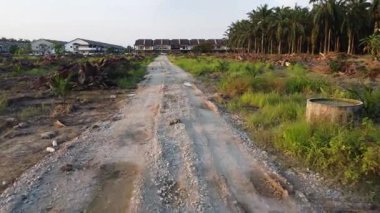 Tarlaya giden izole toprak yolun havadan görüntüsü..