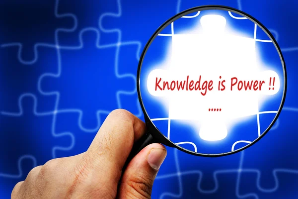 Knowledge is power word. Magnifier and puzzles. — Stock Photo, Image