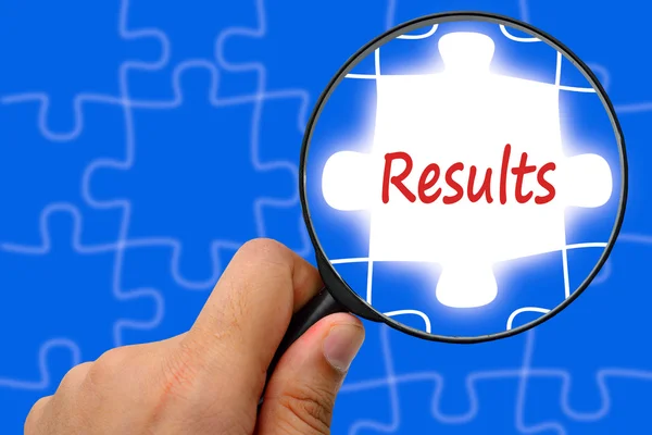 Results word. Magnifier and puzzles. — Stock Photo, Image