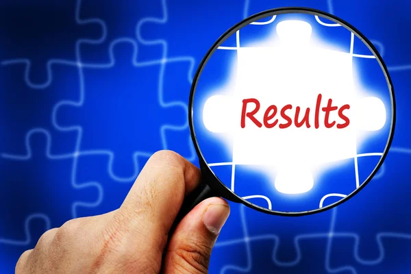 Results word. Magnifier and puzzles. — Stock Photo, Image