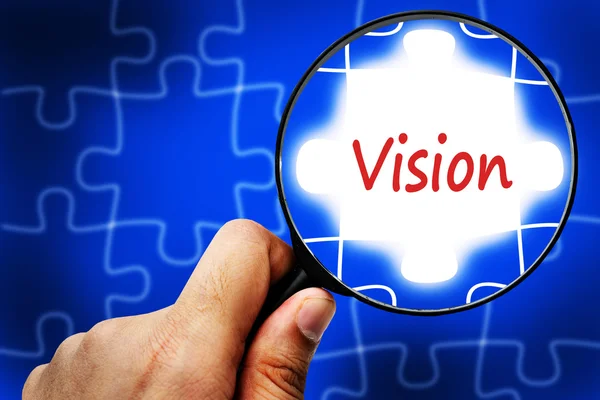 Vision word. Magnifier and puzzles. — Stock Photo, Image