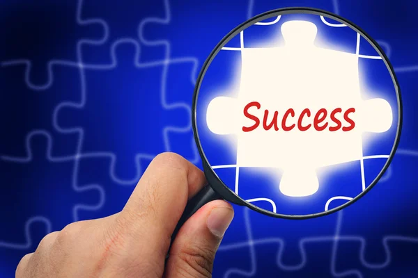 Success word. Magnifier and puzzles. — Stock Photo, Image