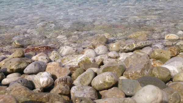 Галька под кристально чистой водой — стоковое фото