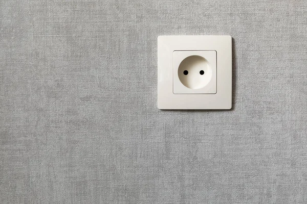 Electrical outlet on the gray wall. Electricity, safety, energy saving concept. — Stock Photo, Image