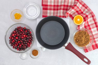 Cranberry sauce recipe. Fresh cranberries, orange, brown sugar, cinnamon, salt. Ingredients close up, flat lay