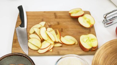 Elma dilimleri ahşap bir kesme tahtasına yakın.