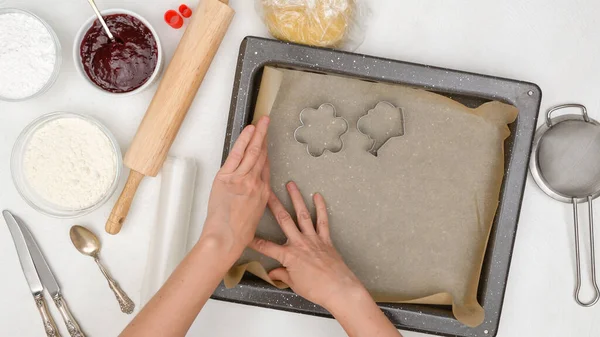 Woman hands line baking pan with parchment paper. Shortbread cookie recipe. Step by step baking process