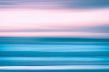 Creative abstract background. Sunset over the sea in light pink and blue colors, line art, soft blur