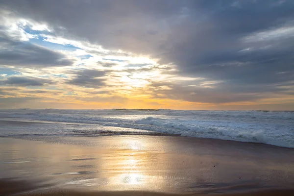 Peaceful tranquil scene, beautiful sunset on the beach with dramatic colorful sky on background