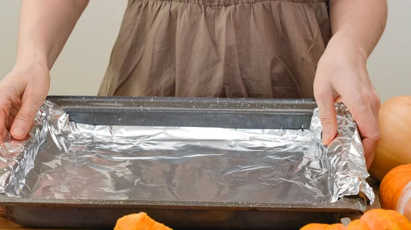 Woman Hands Placing Aluminum Foil Baking Pan Baking Pumpkin Step — Stock Photo, Image