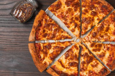 Geleneksel peynirli pizza, köpüklü altın rengi bir üstü ve domates sosu tabanlı..