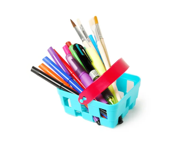 Color pencils, felt-tip pens, brushesin a blue toy basket isolated on  white background. School shopping theme. — Stock Photo, Image