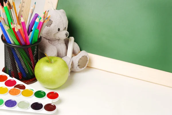School or office supplies with chalkboard watercolor paints, colored pencils and markers, close-up — Stock Photo, Image