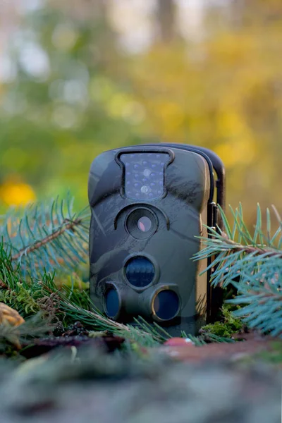 Advertising photo of Trap or Hunting Camera With Infrared Light and a motion detector on the Forest Floor